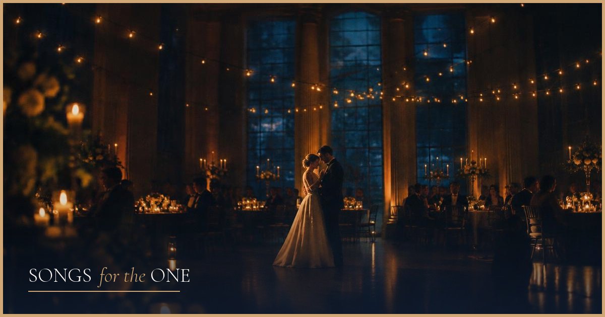 A bride and groom sharing their first dance in a candlelit reception hall