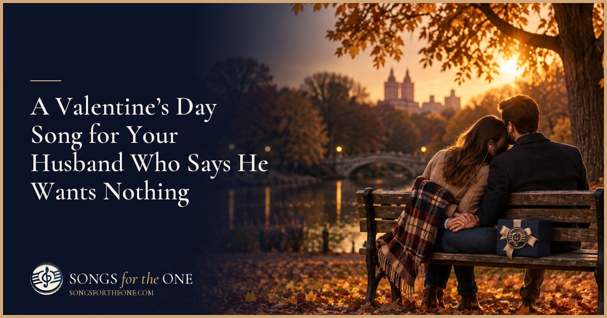 A wife sits beside her husband at their kitchen table as he listens through headphones, with a small Valentine’s envelope nearby.
