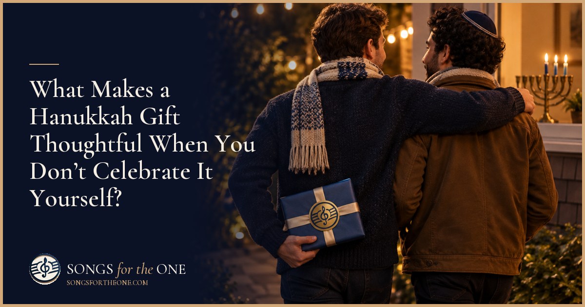 Guest handing a small wrapped gift to a friend beside a table set with latkes and an unlit Hanukkah menorah