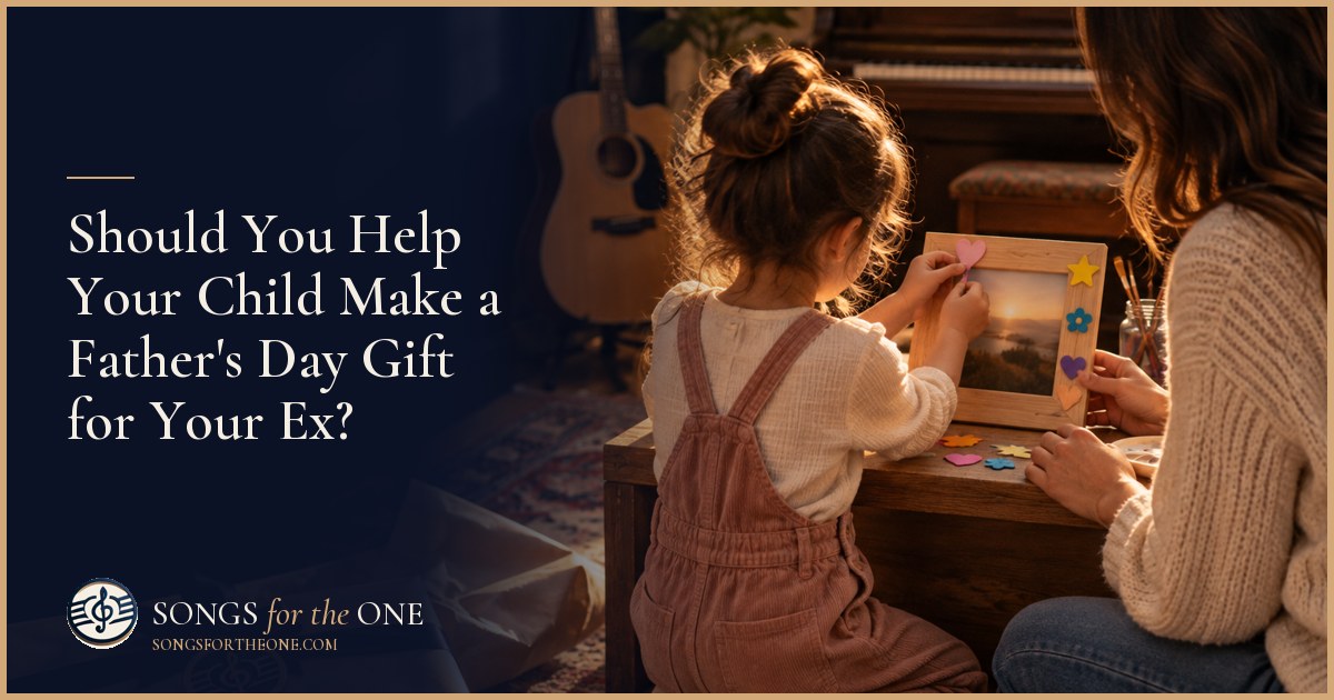 Parent helping a child tie string around a handmade Father's Day gift at a kitchen table with crayons and craft paper.